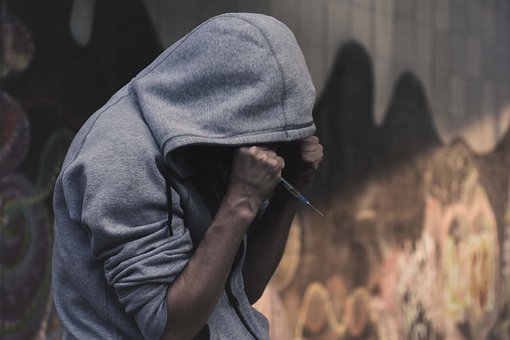 Upset Person Holding a Syringe Image