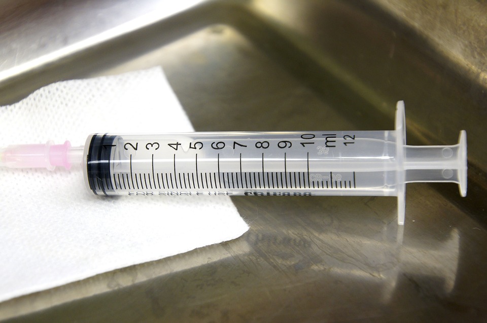 syringe on a metal tray image