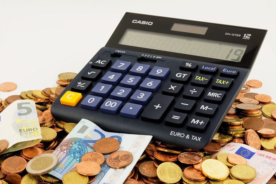 Calculator Surrounded by Money Image