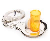 handcuffs around a pill bottle image