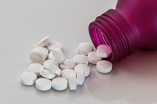 Pills poured out of bottle image
