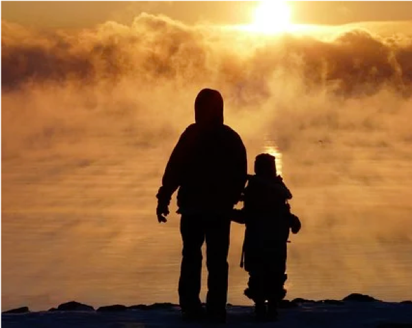 Man and child at sunset