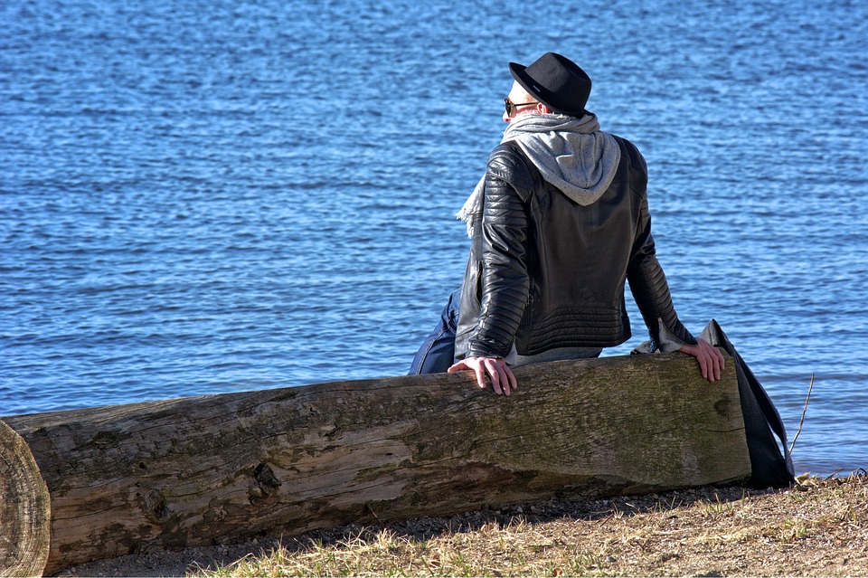 person sitting on log