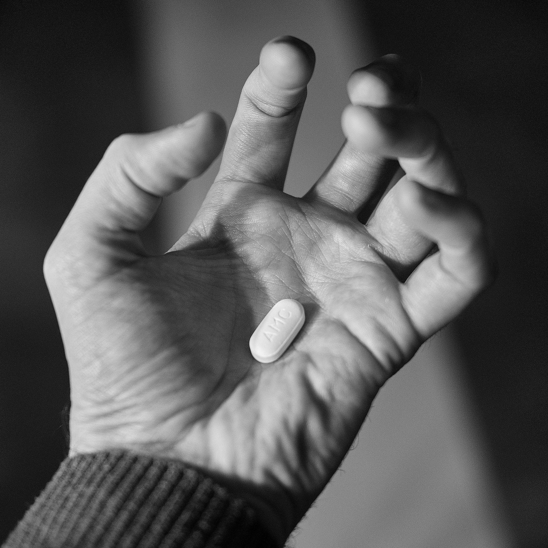 hand holding a pill